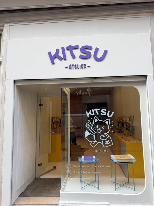 La devanture blanche de l'Atelier Kitsu au 23 rue de la Clef, avec le logo violet et le renard sur la vitrine